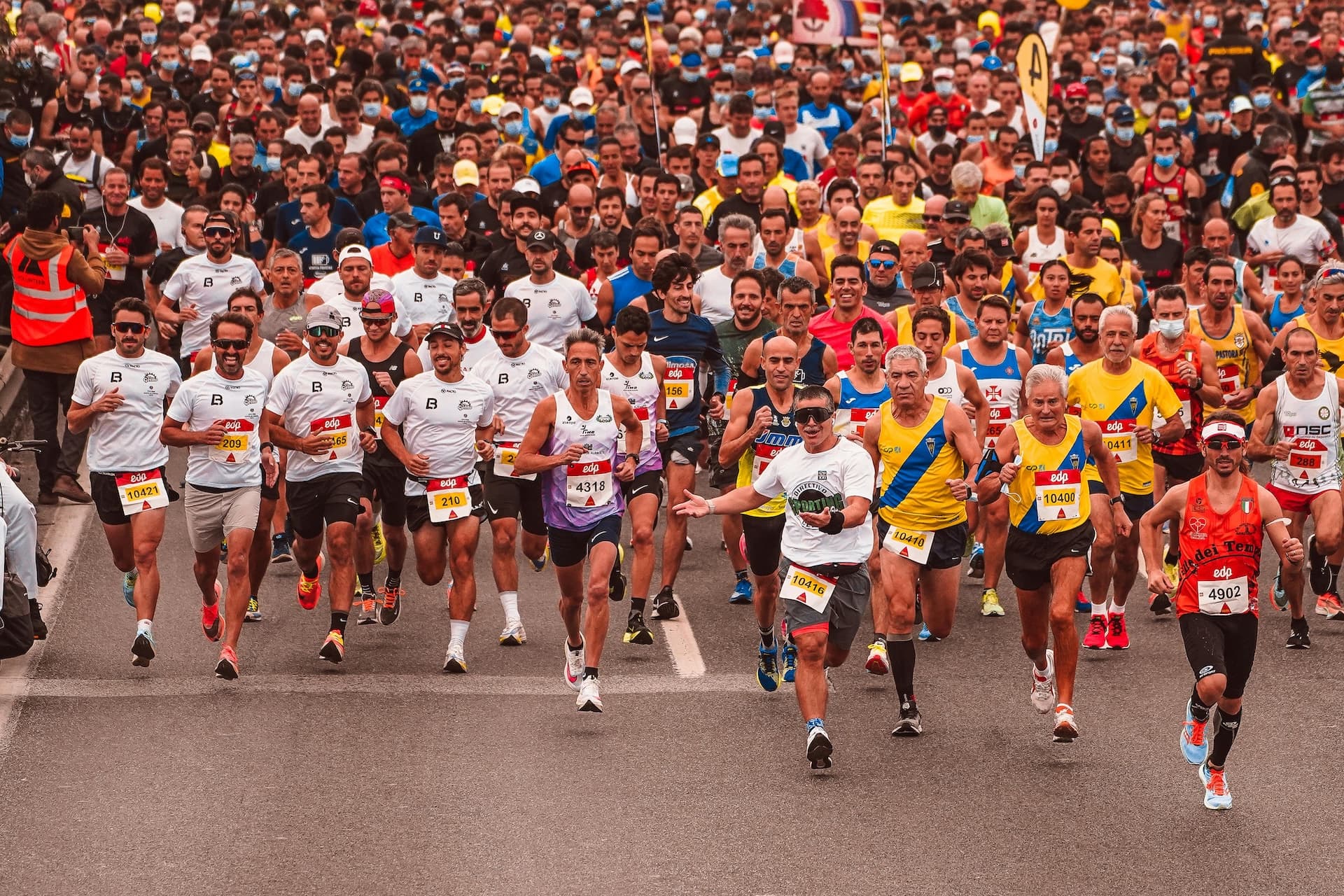 Large crowd of marathon runners during event week showing the scale of events GoStrive helps manage